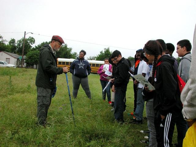   Paul Rodman &nbsp;and group looking closely at the prairie. 