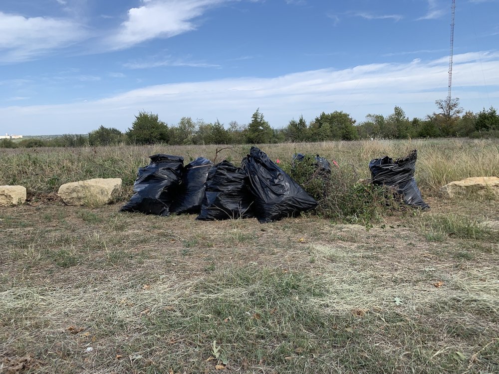  Several 55 gallon bags were filled with invasive grass 