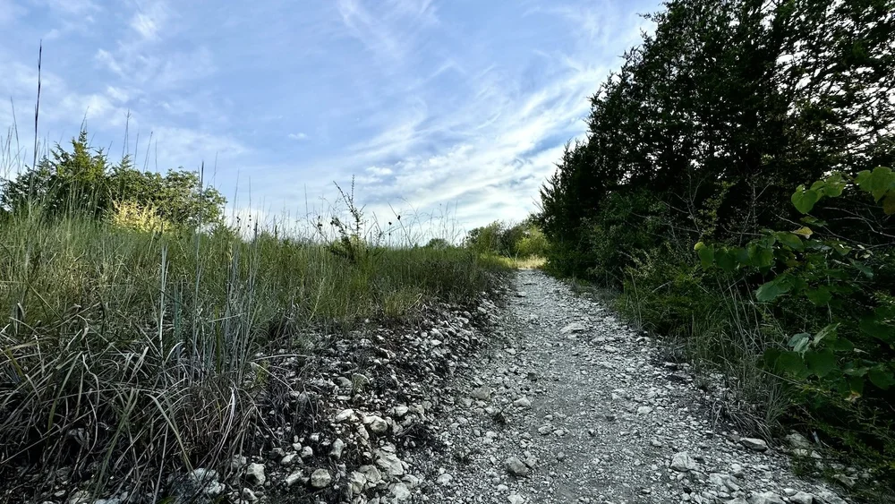  Climbing the path up a steep hill with blue sky ahead. 