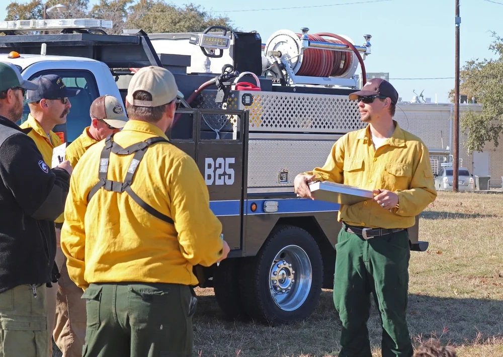  Certified Burn Manager,  Jared Hall , (right) addressing his crew prior to the burn. 
