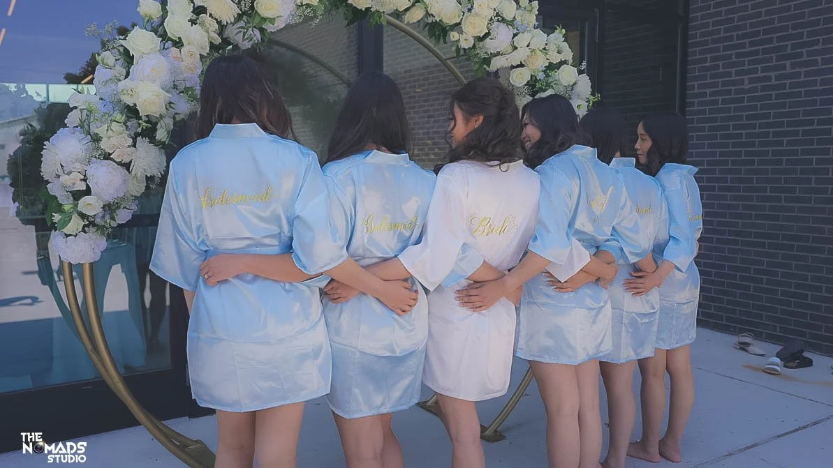 Group of women in satin robes, some with 