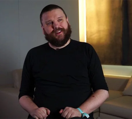 White man with a beard, Haraldur Thorleifsson, sits in a wheelchair with a pleasant expression
