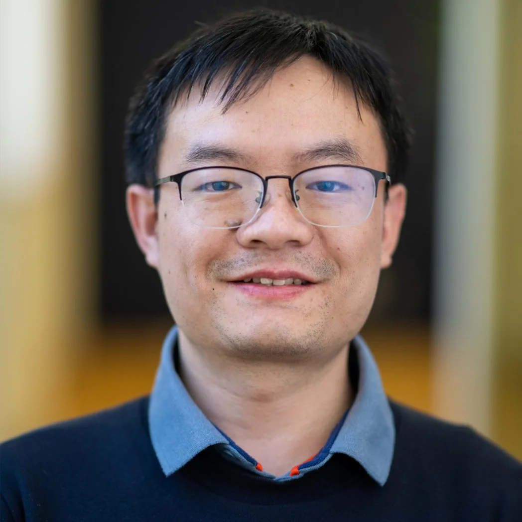 This is a professional headshot photo of Jianjun Larry Zhu