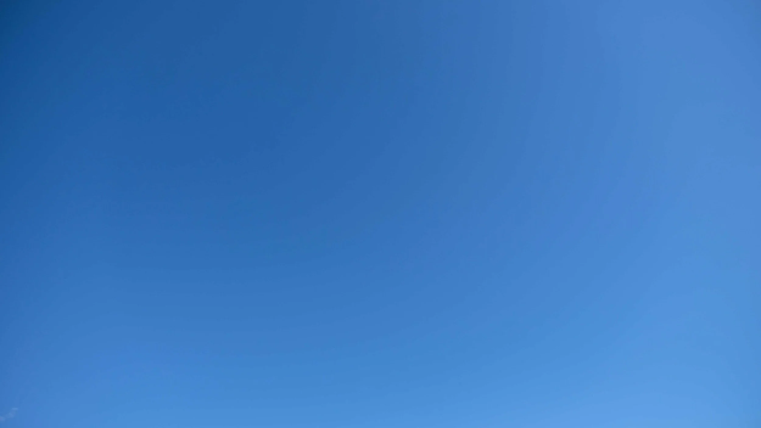 Clear blue sky with no clouds or objects.