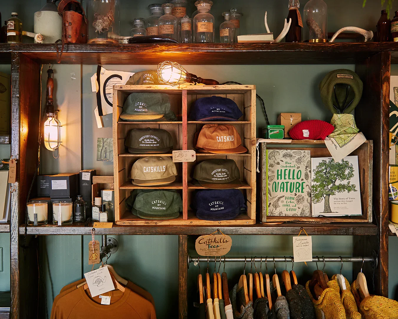 Shelves in a store with hats, books, and clothing.