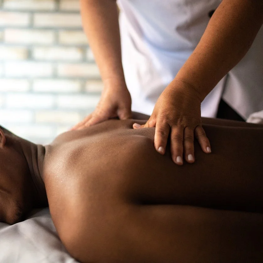 black-man-smiling-getting-back-massage.jpg