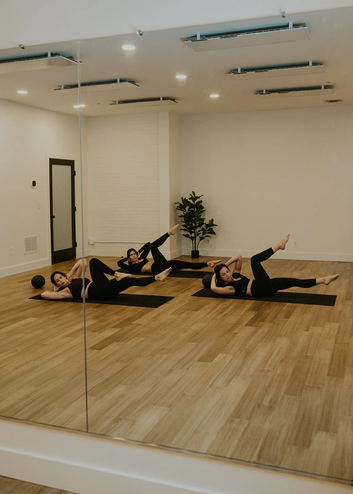 Three women doing bicycle crunch