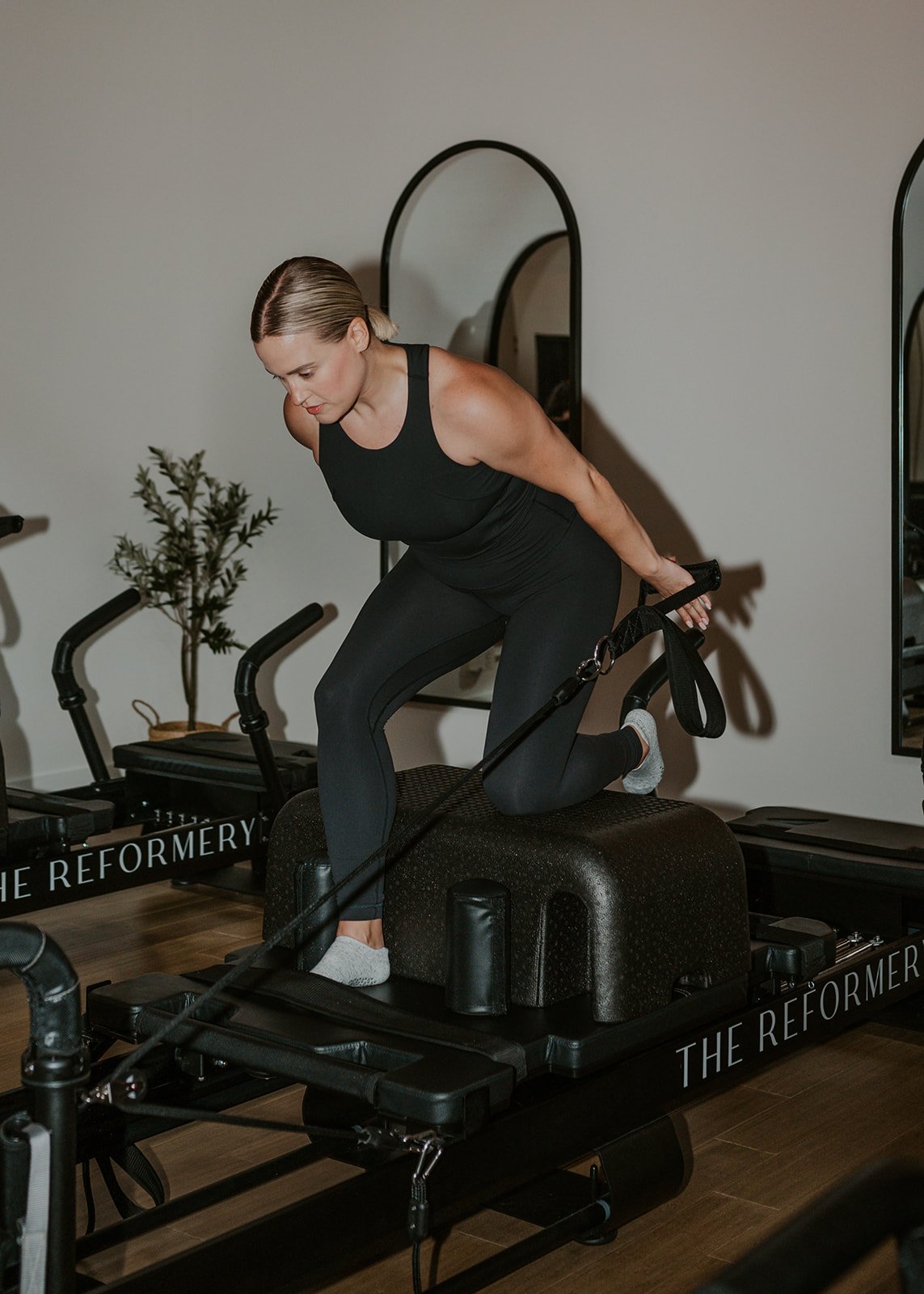 A woman practicing machine Pilates