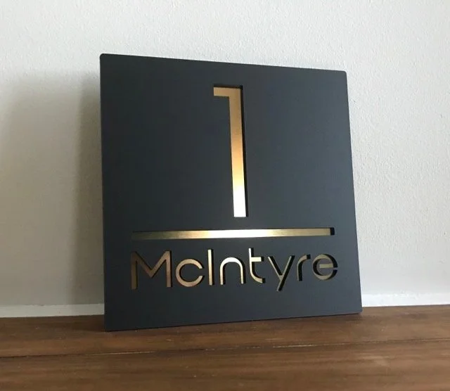 30x30cm House sign, black with brushed gold letters.