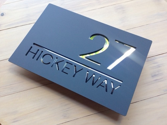 Mid grey sign with reflective mirror letters