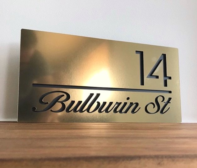 40x20cm House sign, brushed gold with black letters.