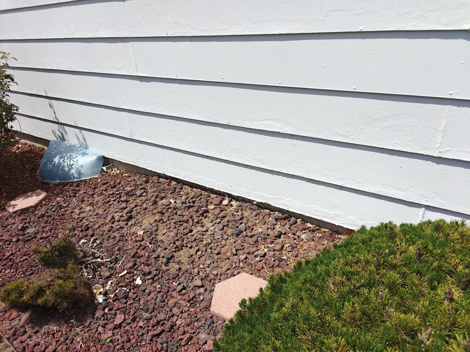 Water-damaged lower siding on the rear elevation of an Arvada home before repair.
