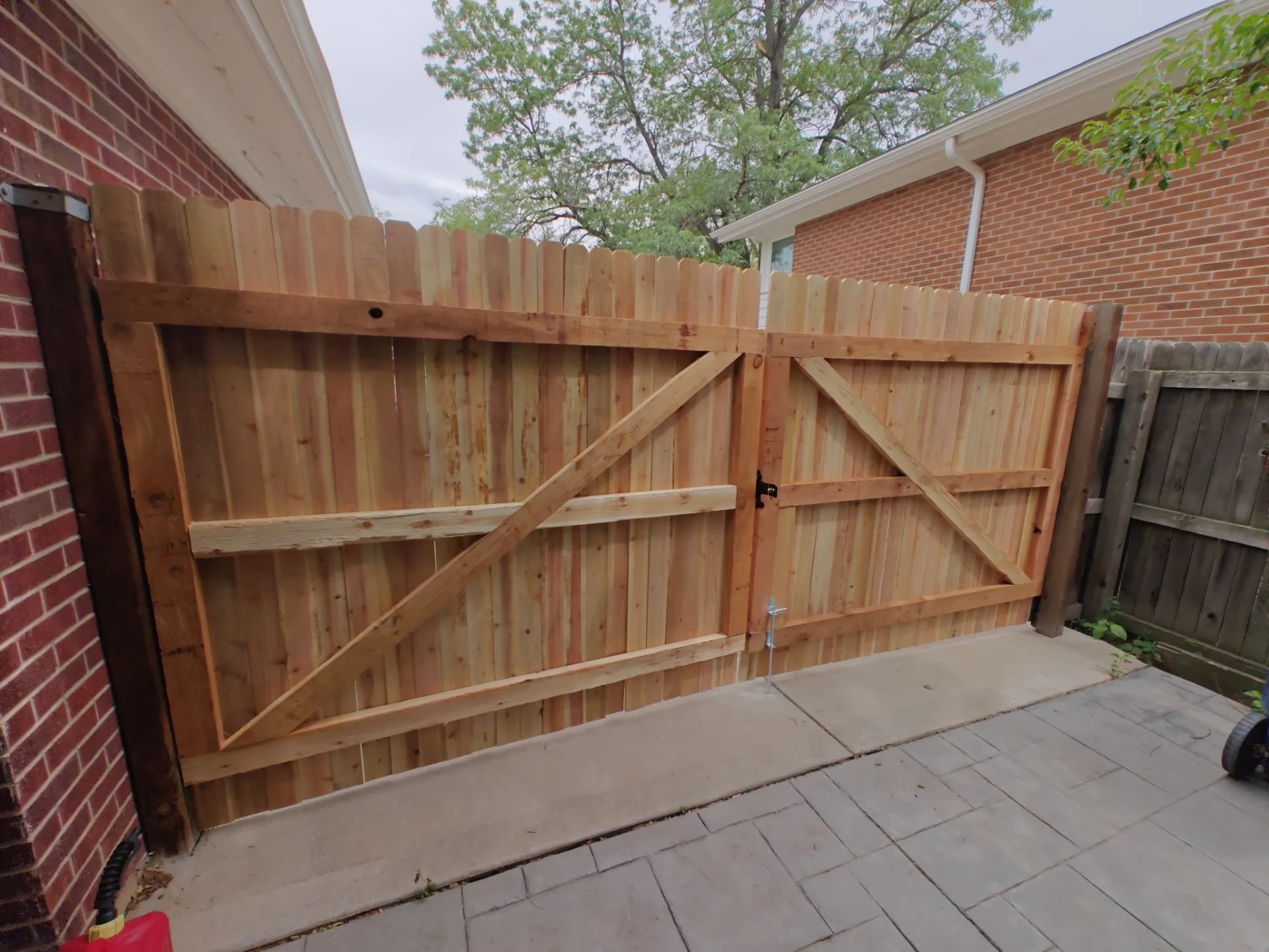 Finished cedar double gate matching the existing privacy fence in Arvada, CO.
