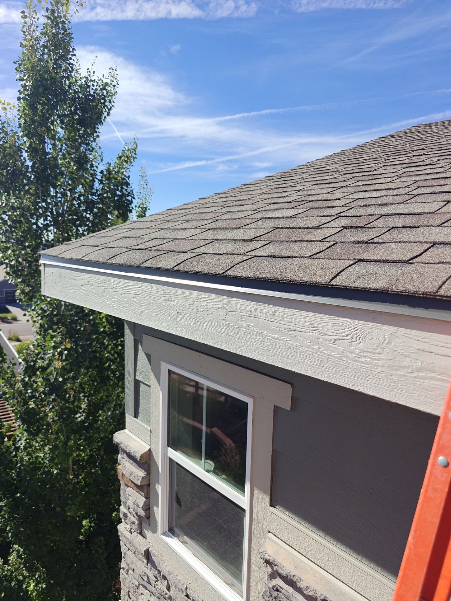 New fascia board being fitted to match an existing Arvada home exterior