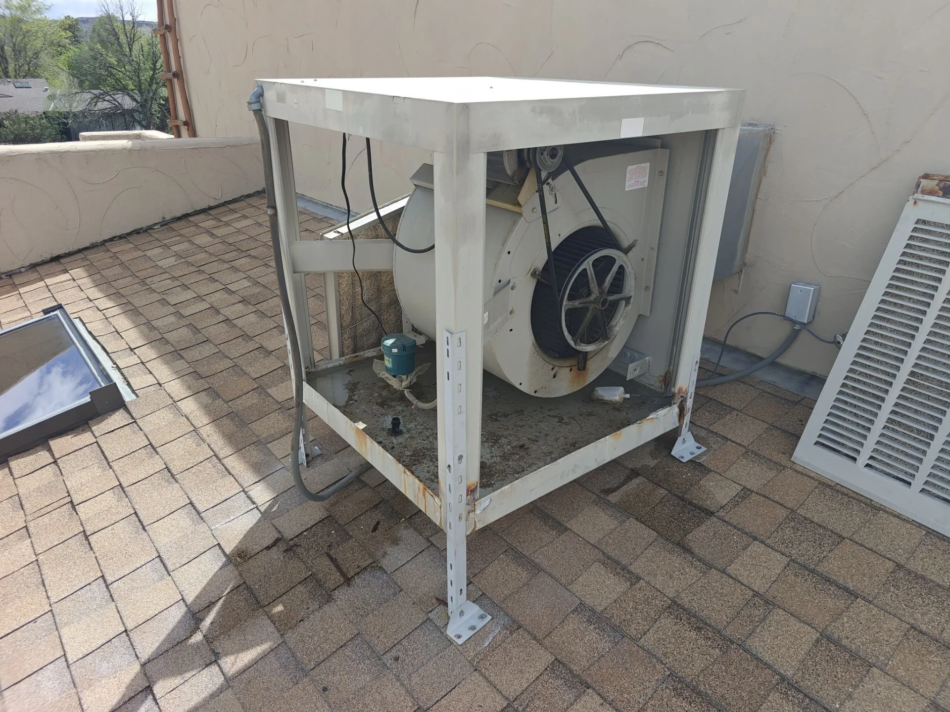 Residential evaporative cooler receiving routine maintenance