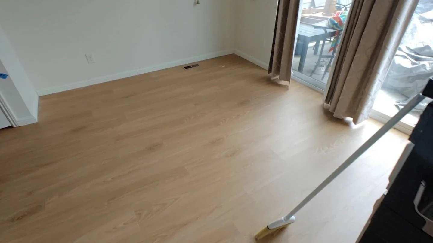 Existing baseboards reinstalled after LVP flooring installation for a clean finish without shoe molding in Broomfield, CO.