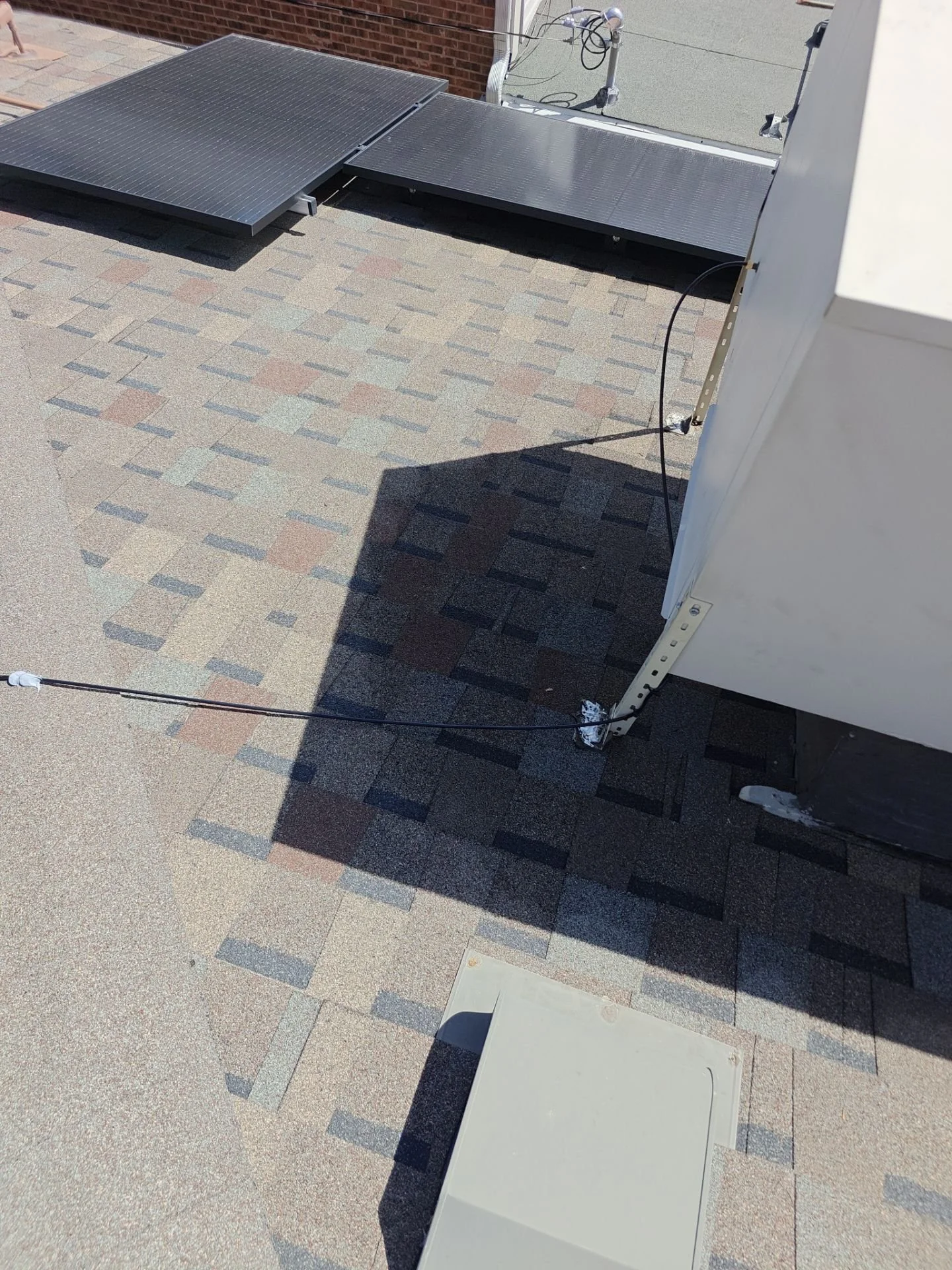 Rooftop evaporative cooler and exterior water-line area at a Wheat Ridge, Colorado home.