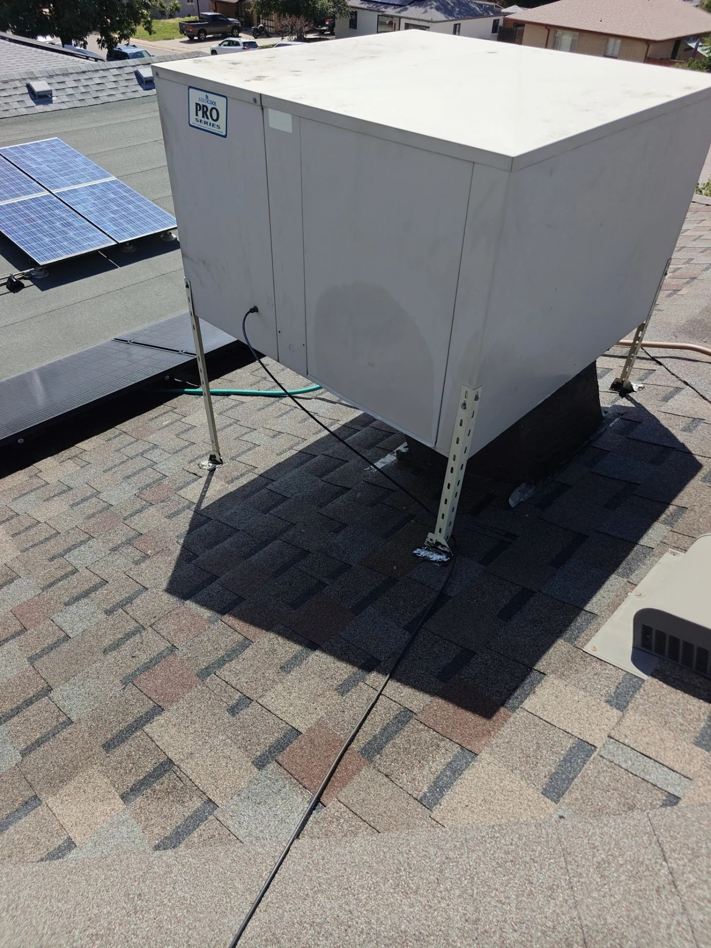 Rooftop swamp cooler at a Wheat Ridge, CO home where Arvada Handyman replaced the exterior water supply line.