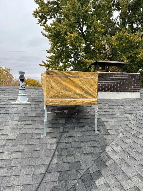 Technician servicing a residential swamp cooler in Arvada, Colorado