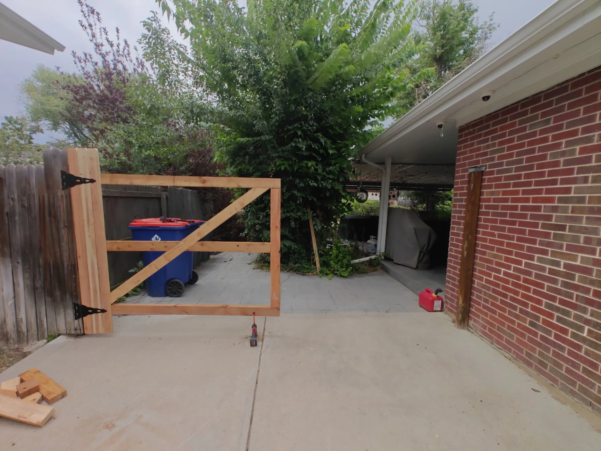 New cedar double driveway gate built on-site with heavy-duty black hardware in Arvada.