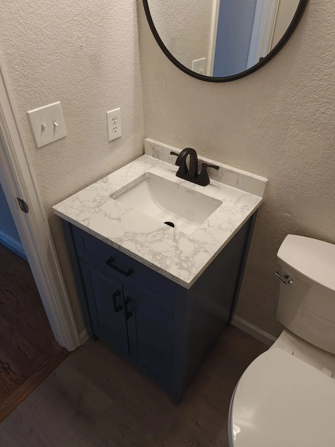 A new blue vanity installed in a bathroom