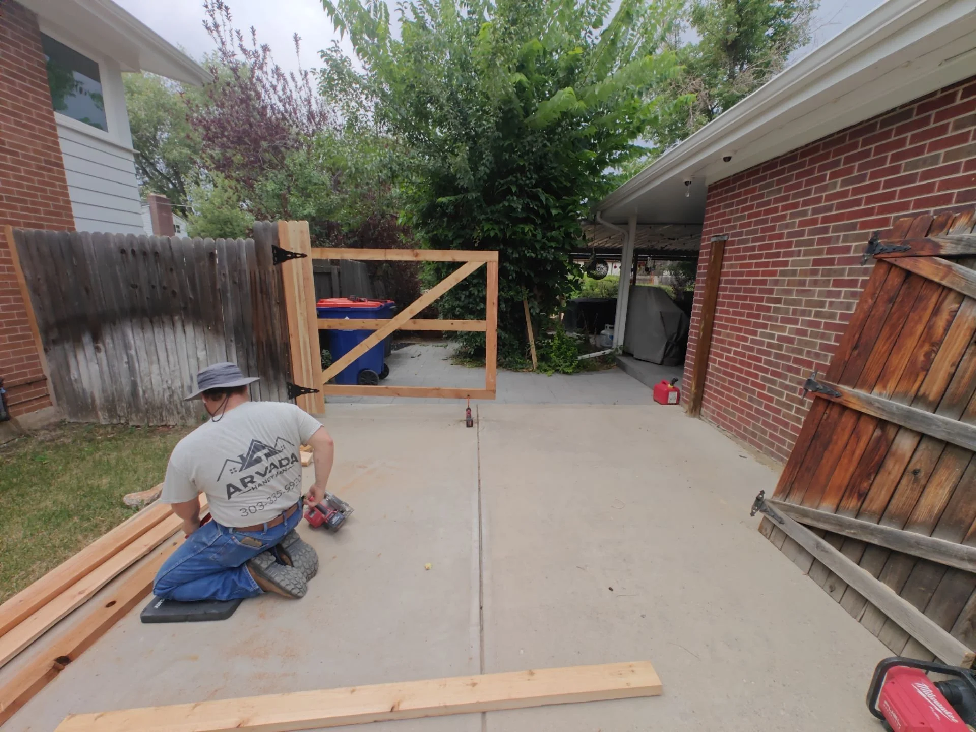 Cedar 2×4 gate framing with diagonal bracing during custom fence gate construction.