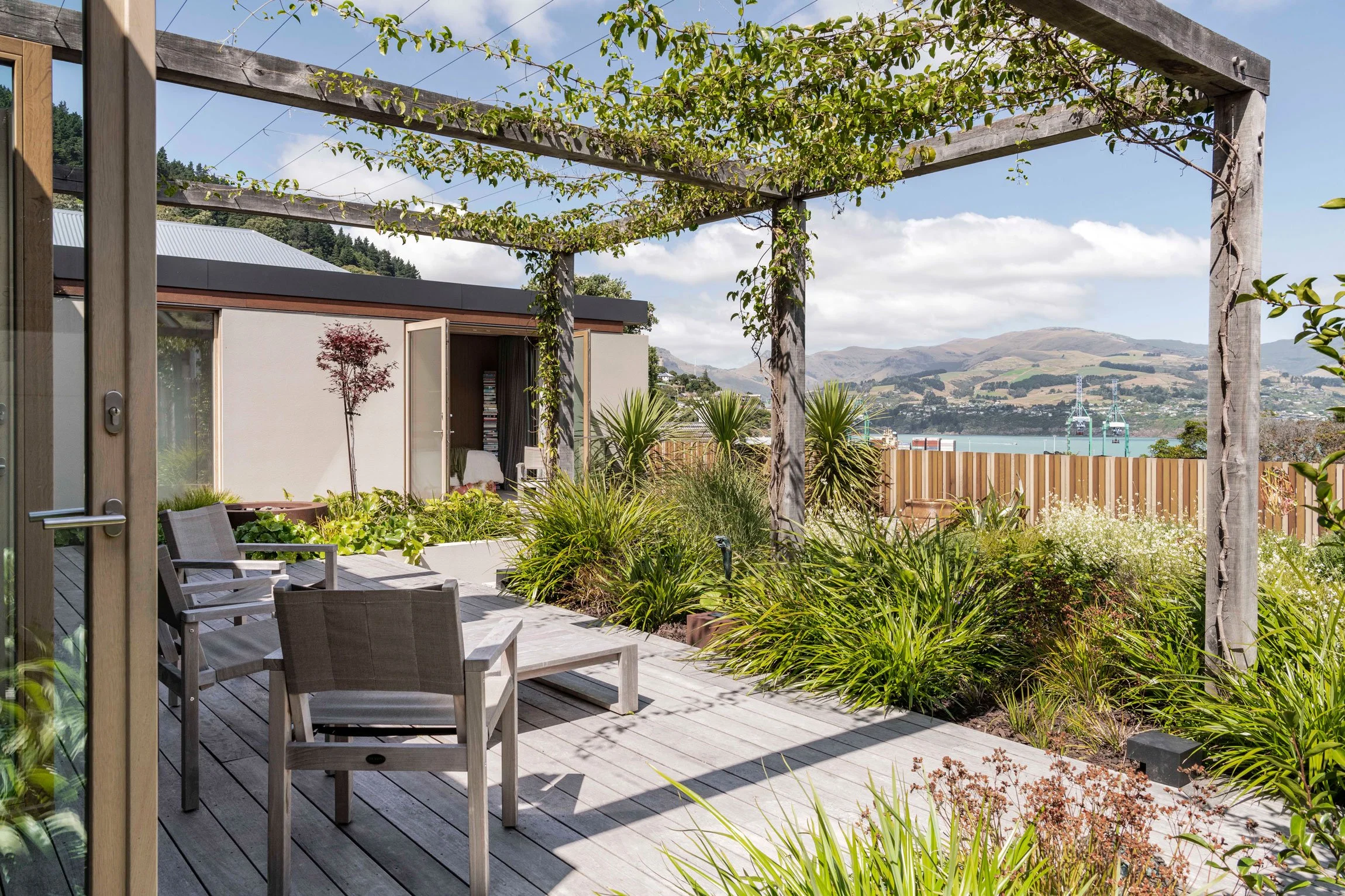 Pergola with vine overlooking Lyttelton Harbour, by Botanic Landscape Architects in Lyttelton, Christchurch