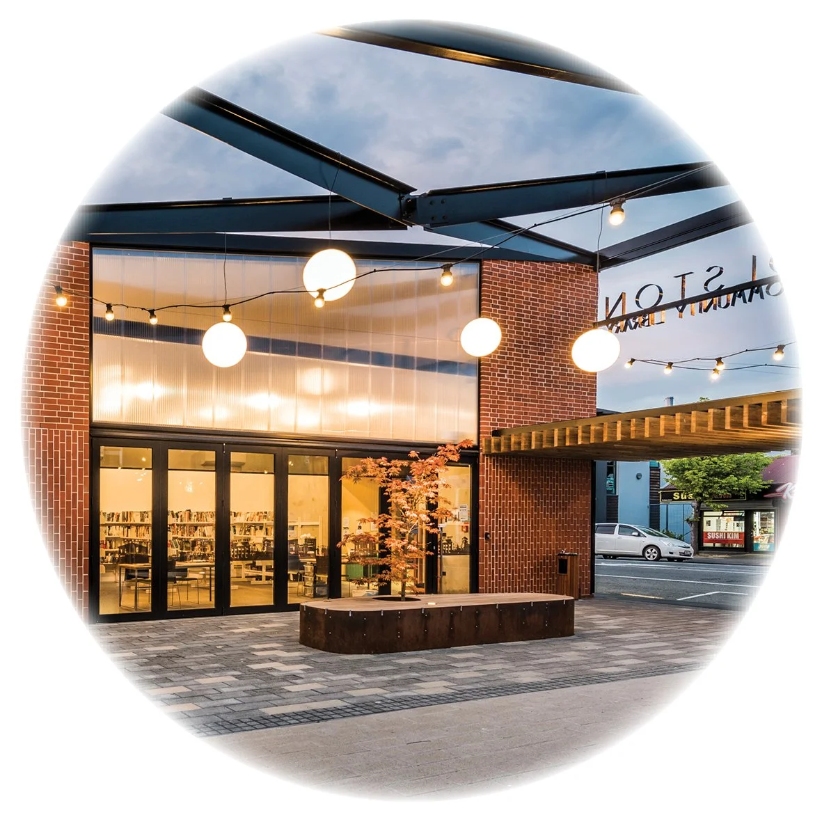 Exterior lighting at Woolston Community Library creates a vibrant community space both day and light.