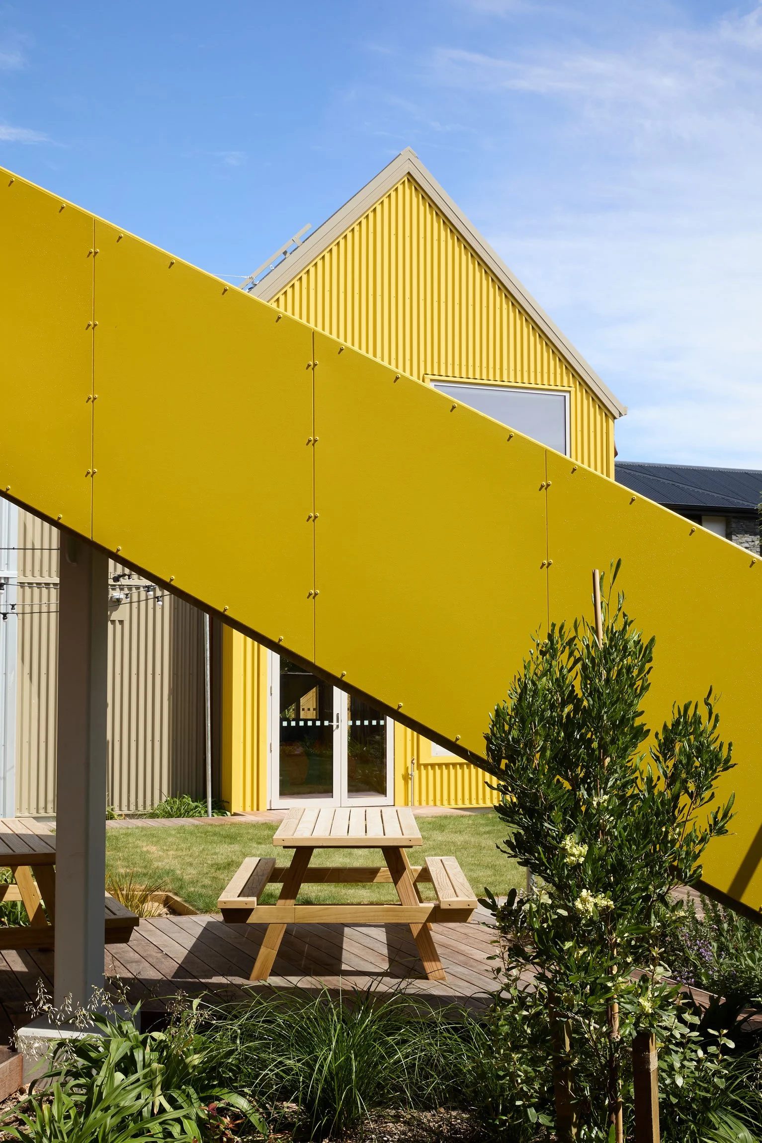 Picnic tables in lawn terrace by Botanic Landscape Architects in Central Christchurch