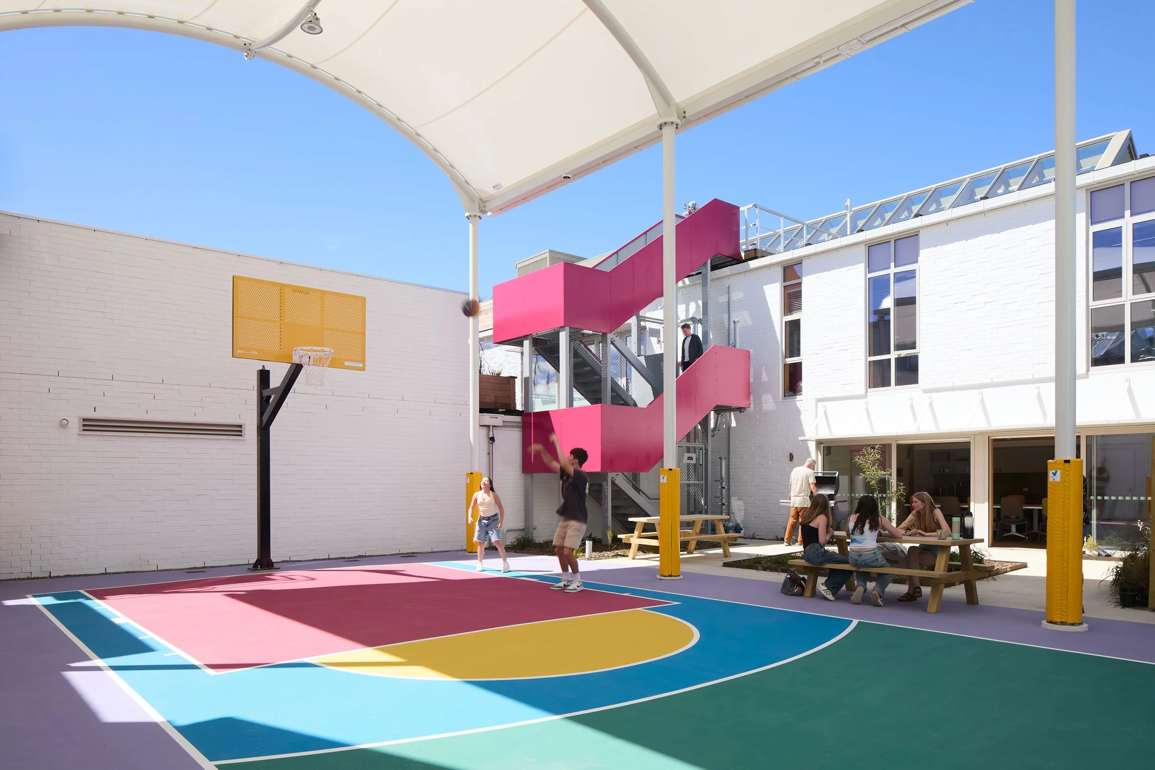 Colourful basketball court with seating, by Botanic Landscape Architects in Central Christchurch