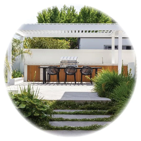 A resort style garden focussed around an outdoor dining and entertainment hub set under a lourved pergola
