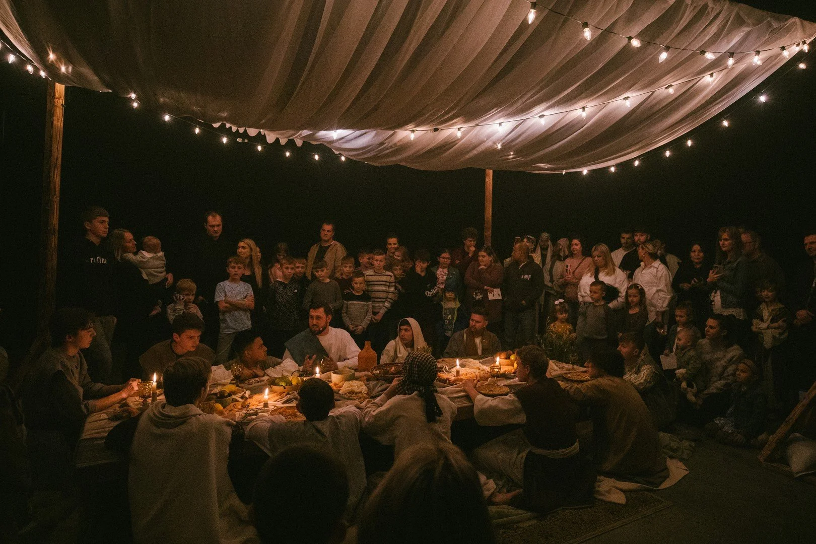 Group of participants listening attentively to the guide at the start of the Journey to the Cross tour.
