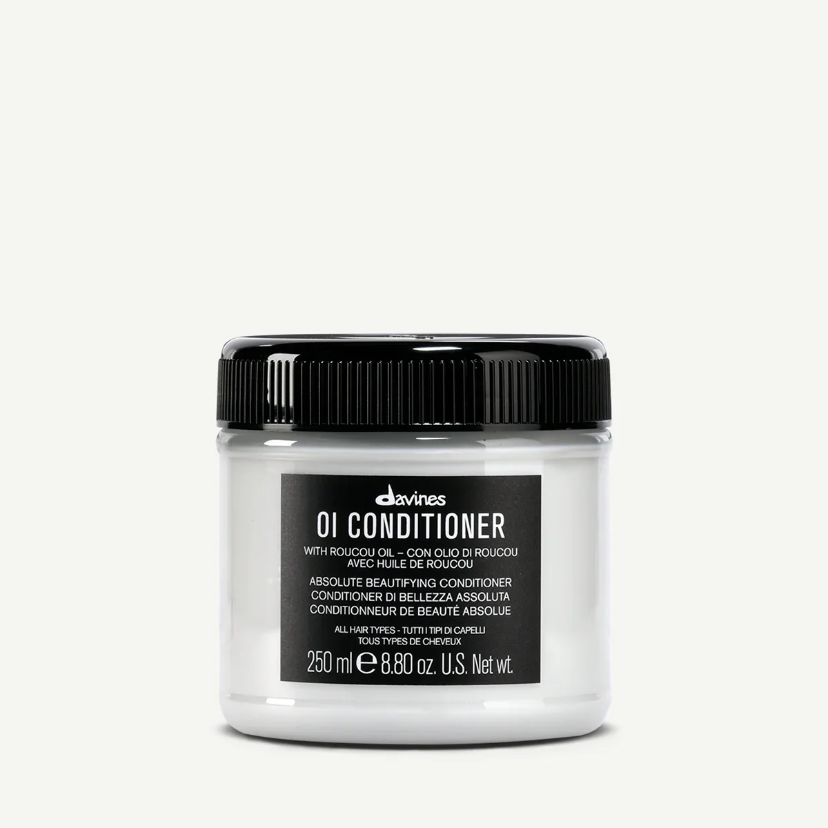 A jar of Davines OI Conditioner with a black lid and a black label on a plain white background.