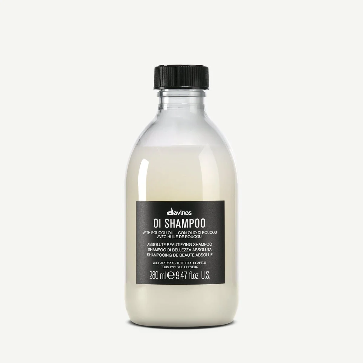 Bottle of Davines Oi Shampoo with black cap and black label.