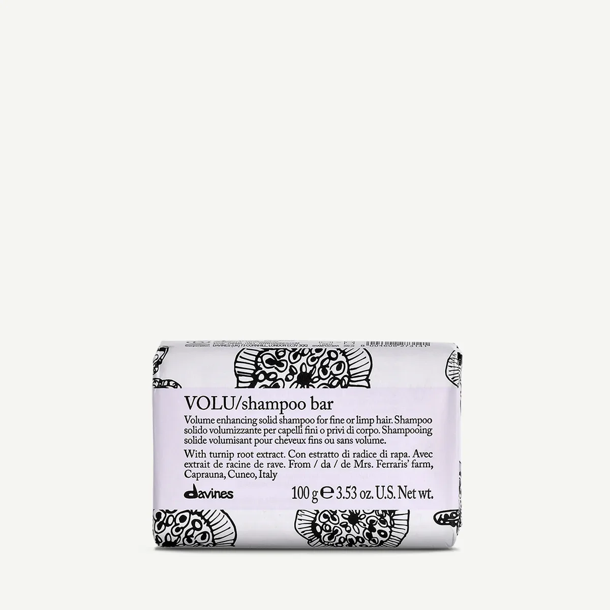 Wrapped bar of VOLU shampoo with black and white design, positioned on a plain background.