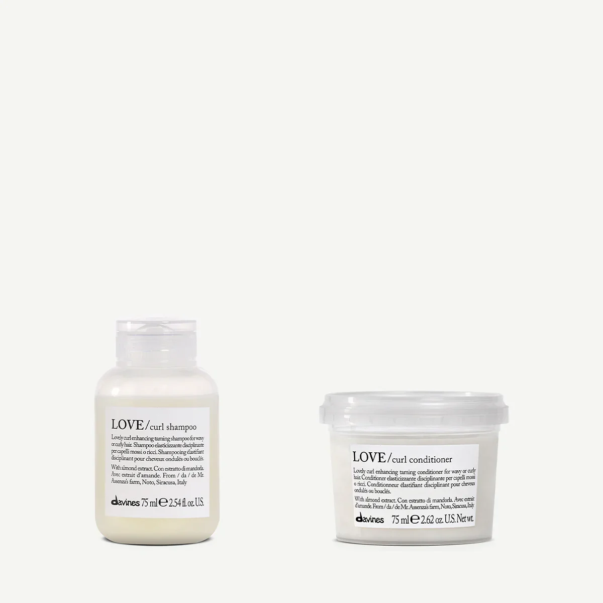 Two Davines hair care products: curl shampoo on the left and curl conditioner on the right, both in white bottles with black text and transparent caps, set against a plain white background.