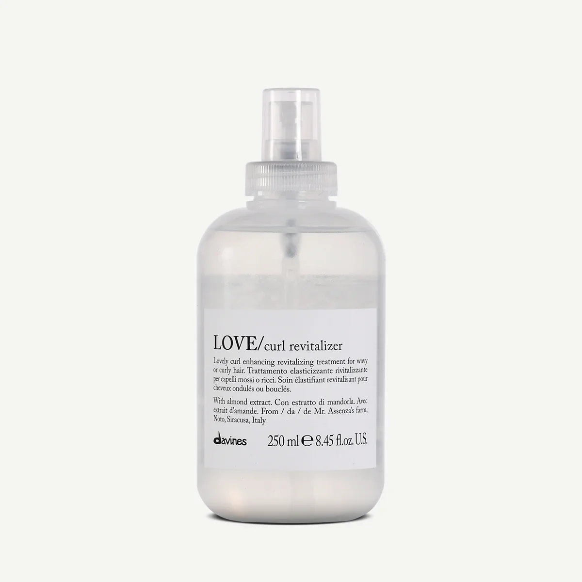 A clear plastic spray bottle labeled 'LOVE curl revitalizer' with a white background.