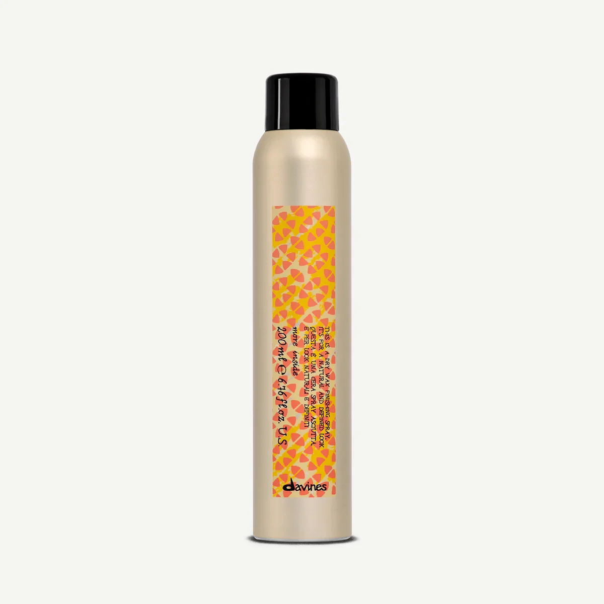 A beige spray bottle with a black cap and a yellow-orange patterned label.