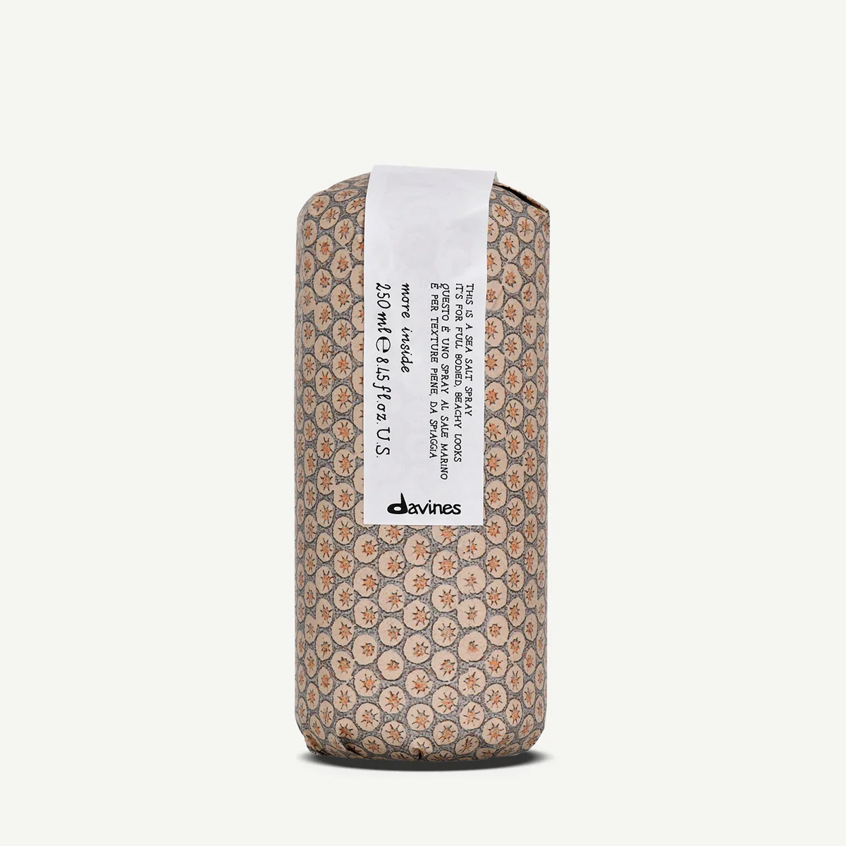 A can of Davines sea salt spray with a patterned cover featuring small, circular starfish designs.