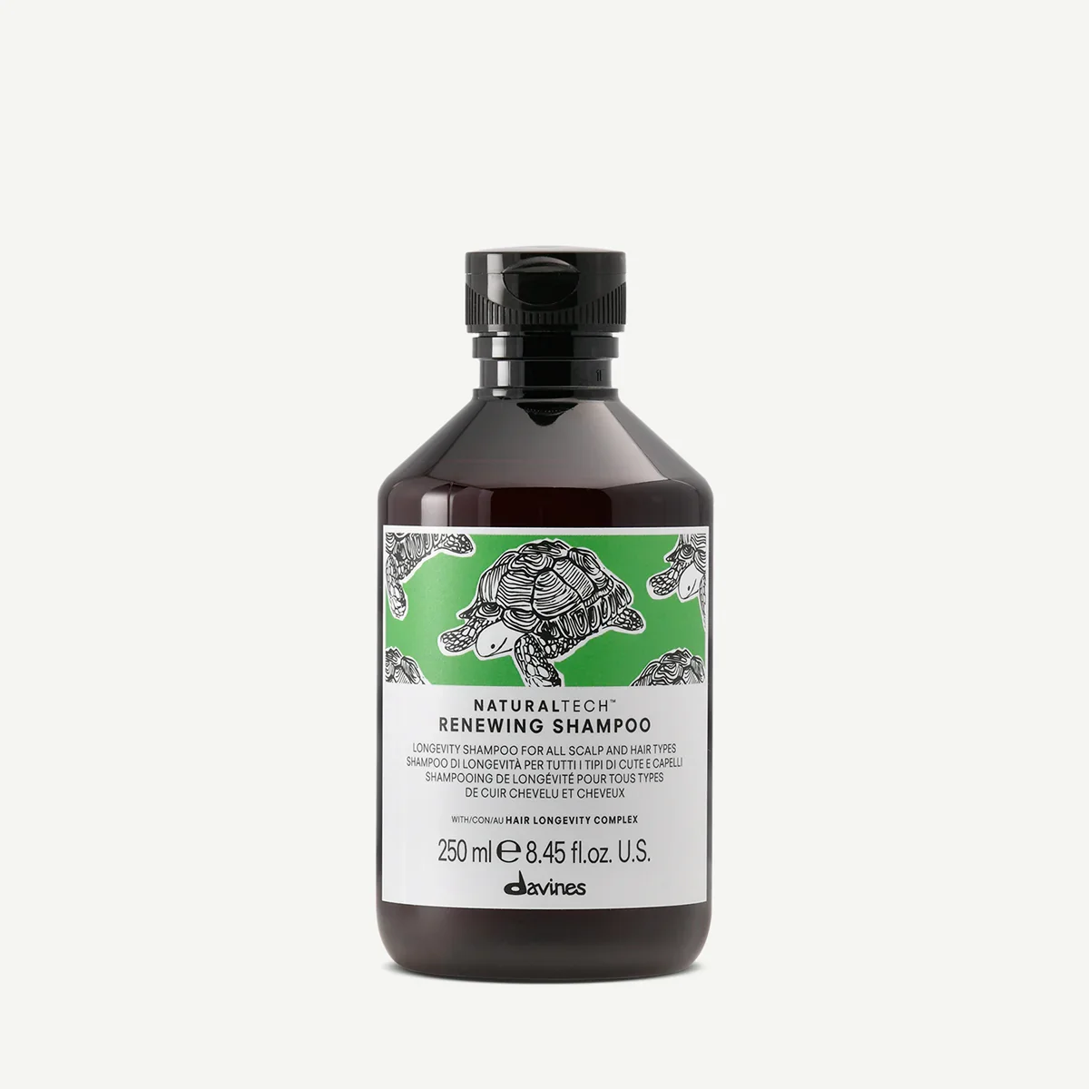 A bottle of Davines Naturaltech Renewing Shampoo with a black flip-top cap and a label featuring a turtle illustration on a green and white background.
