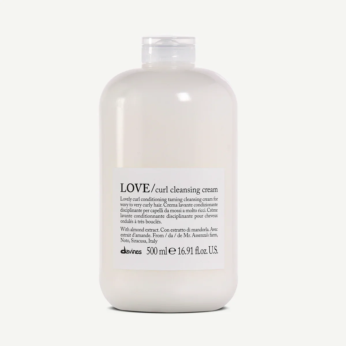 White bottle of Love Curl Cleansing Cream with a white label and black text, containing 500 ml, positioned against a plain background.