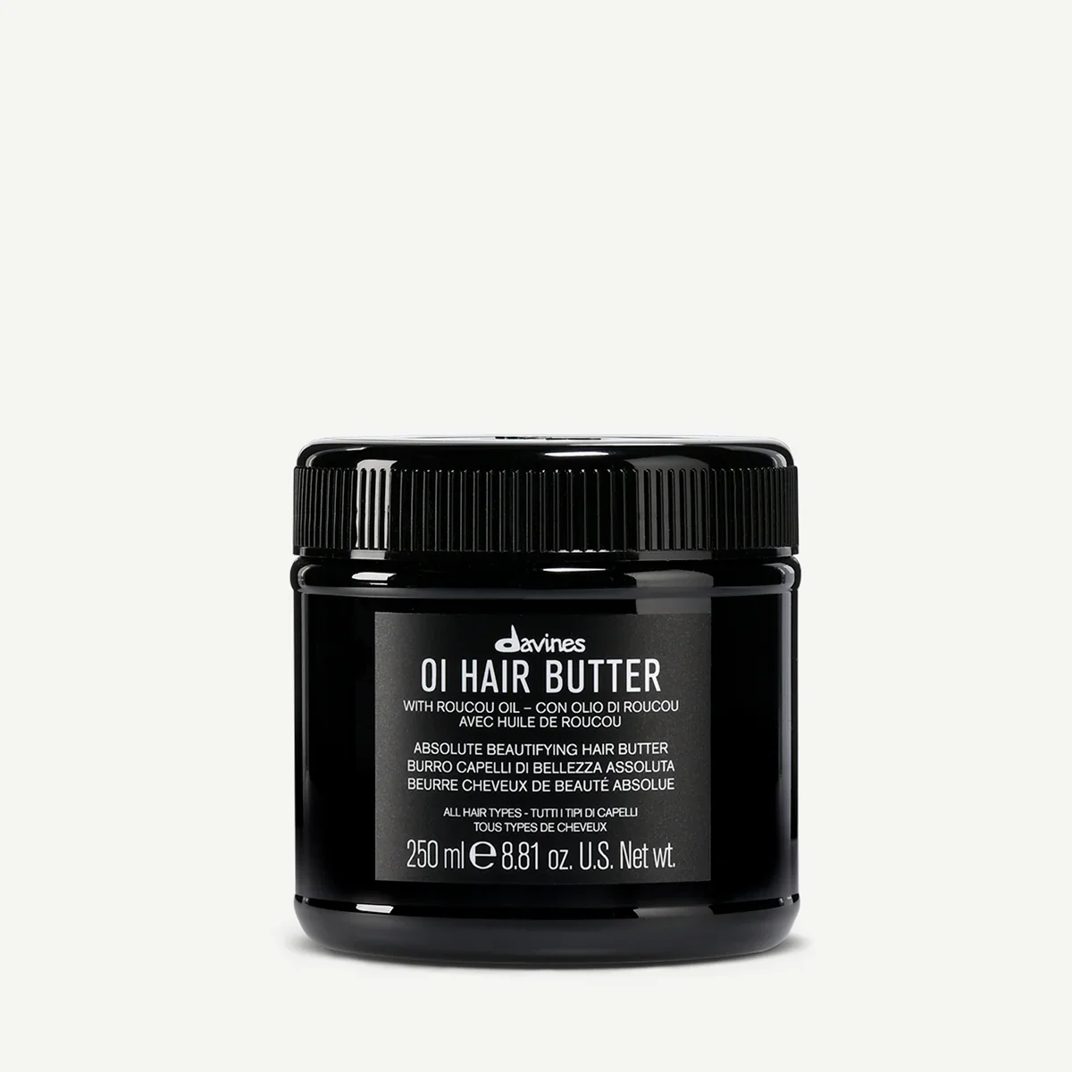 A black container of Davines OI Hair Butter with a screw-on lid and label.