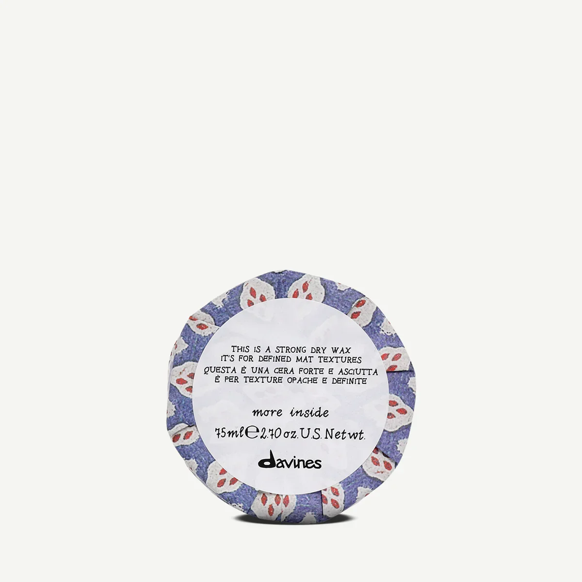 Round container of Davines strong dry wax with a blue, white, and red floral pattern on the packaging.