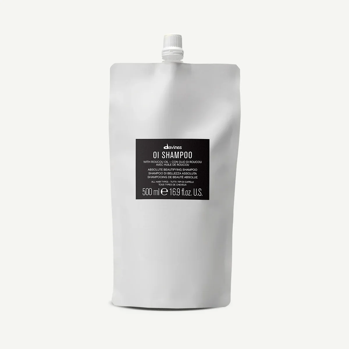 White refill pouch of Davines OI Shampoo with black label, featuring product information and capacity of 500ml.