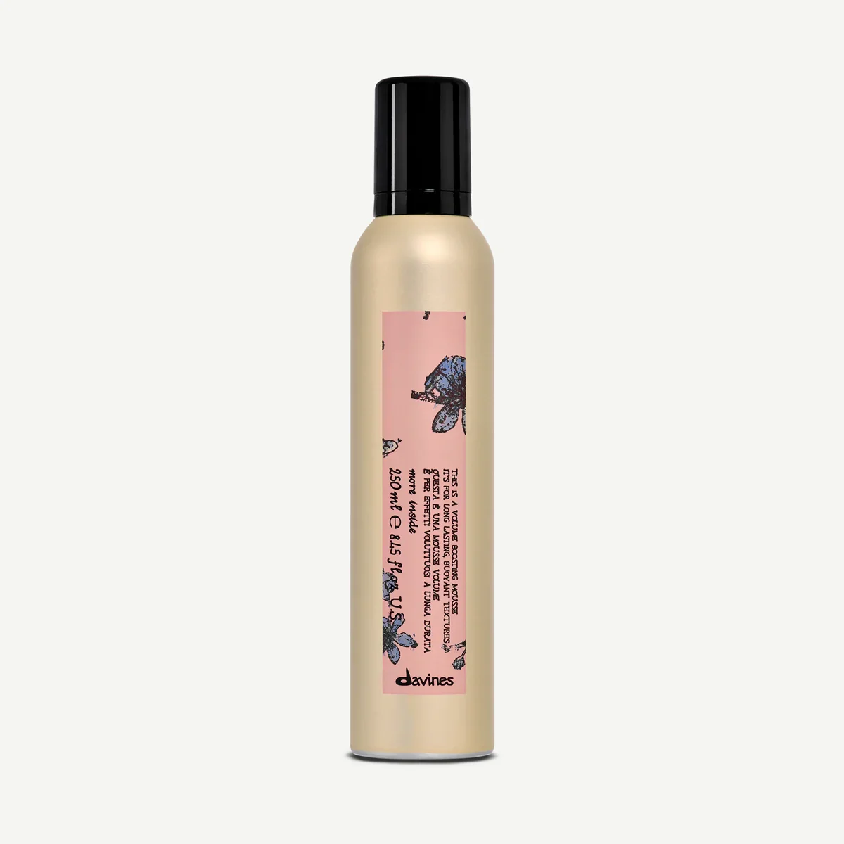 A beige spray bottle with a black cap and pink label featuring blue and black illustrations of bees.