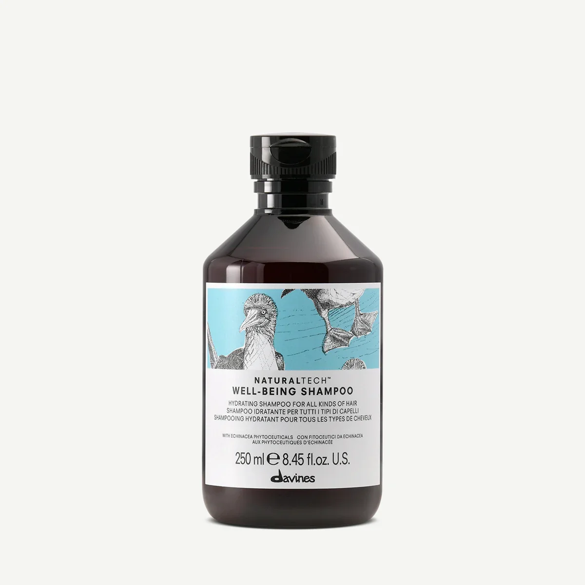 A dark brown bottle of Davines Natural Tech Well-Being Shampoo with a black flip-top cap, featuring a label with illustrations of a heron and a duck in water and text describing the product as a hydrating shampoo for all hair types.