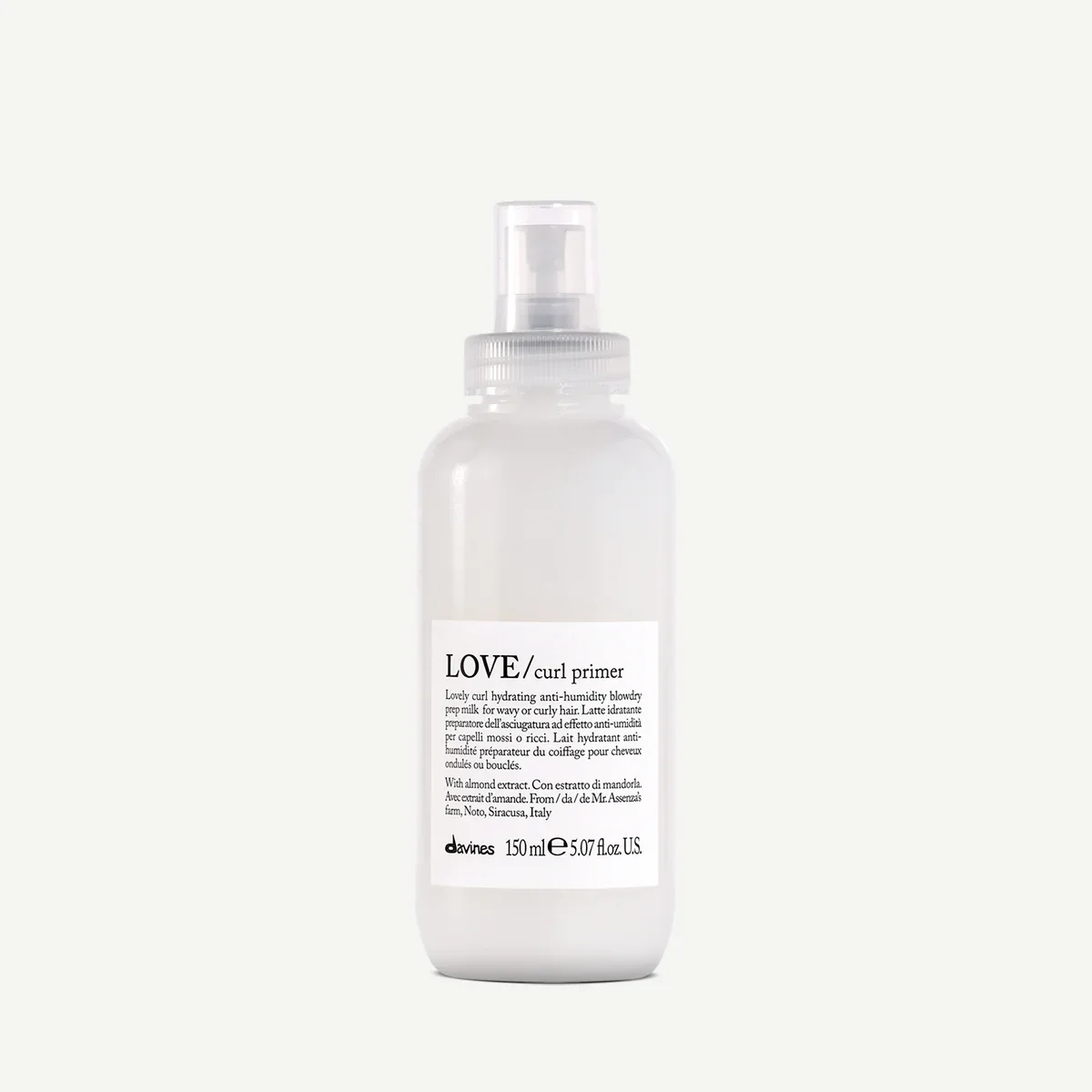 A white plastic spray bottle labeled 'LOVE / curl primer' with a spray nozzle on top, designed for hair styling.
