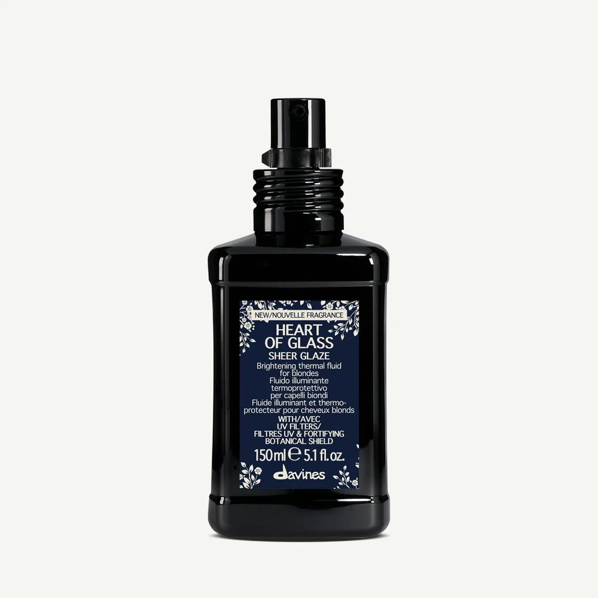 A black spray bottle of Davines Heart of Glass Sheer Glaze with a label describing its use as a brightening thermal fluid for blondes, with UV filters and botanical shield, 150ml.