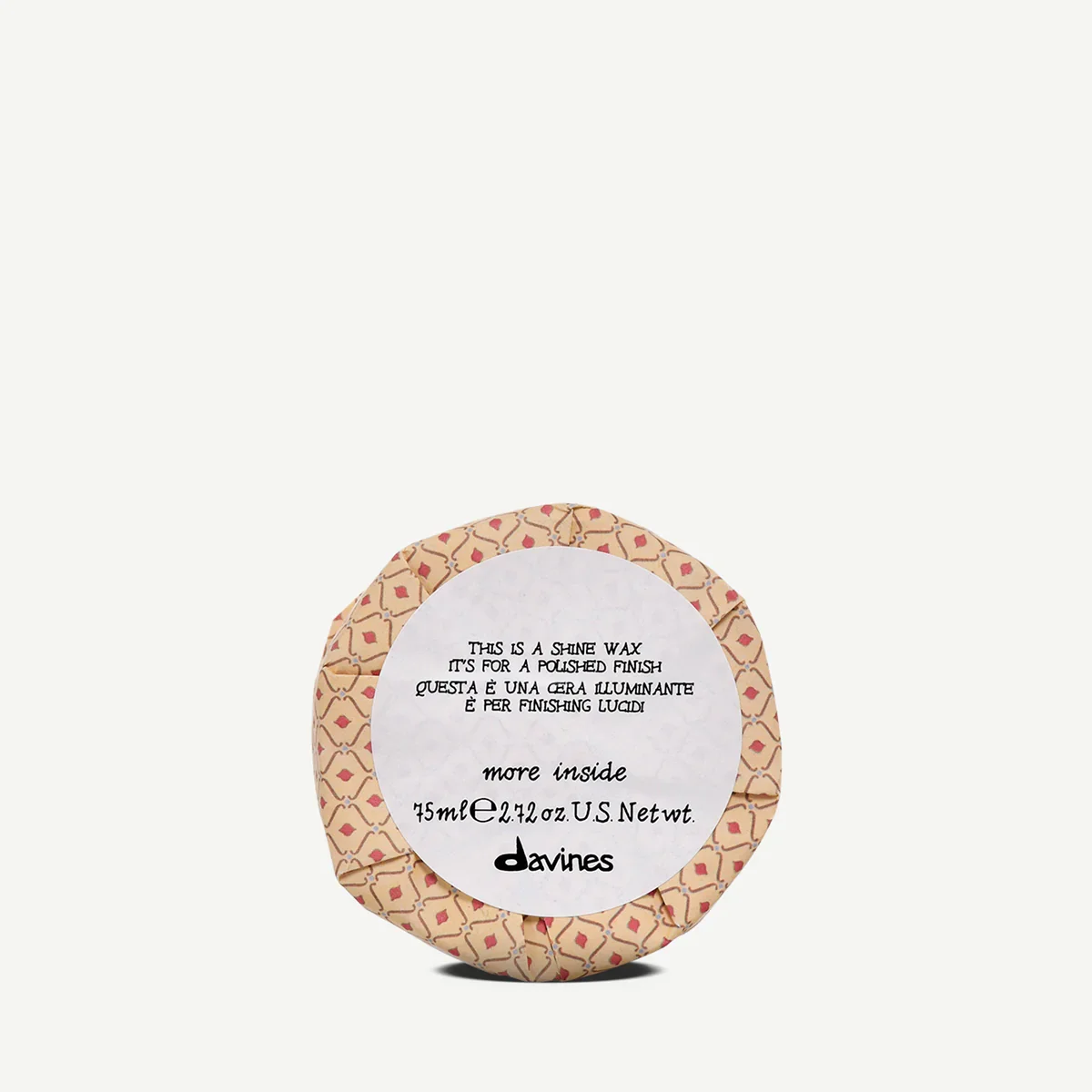 A round container of Davines shine wax with patterned wrapping and a white label that provides product information in English and Italian.