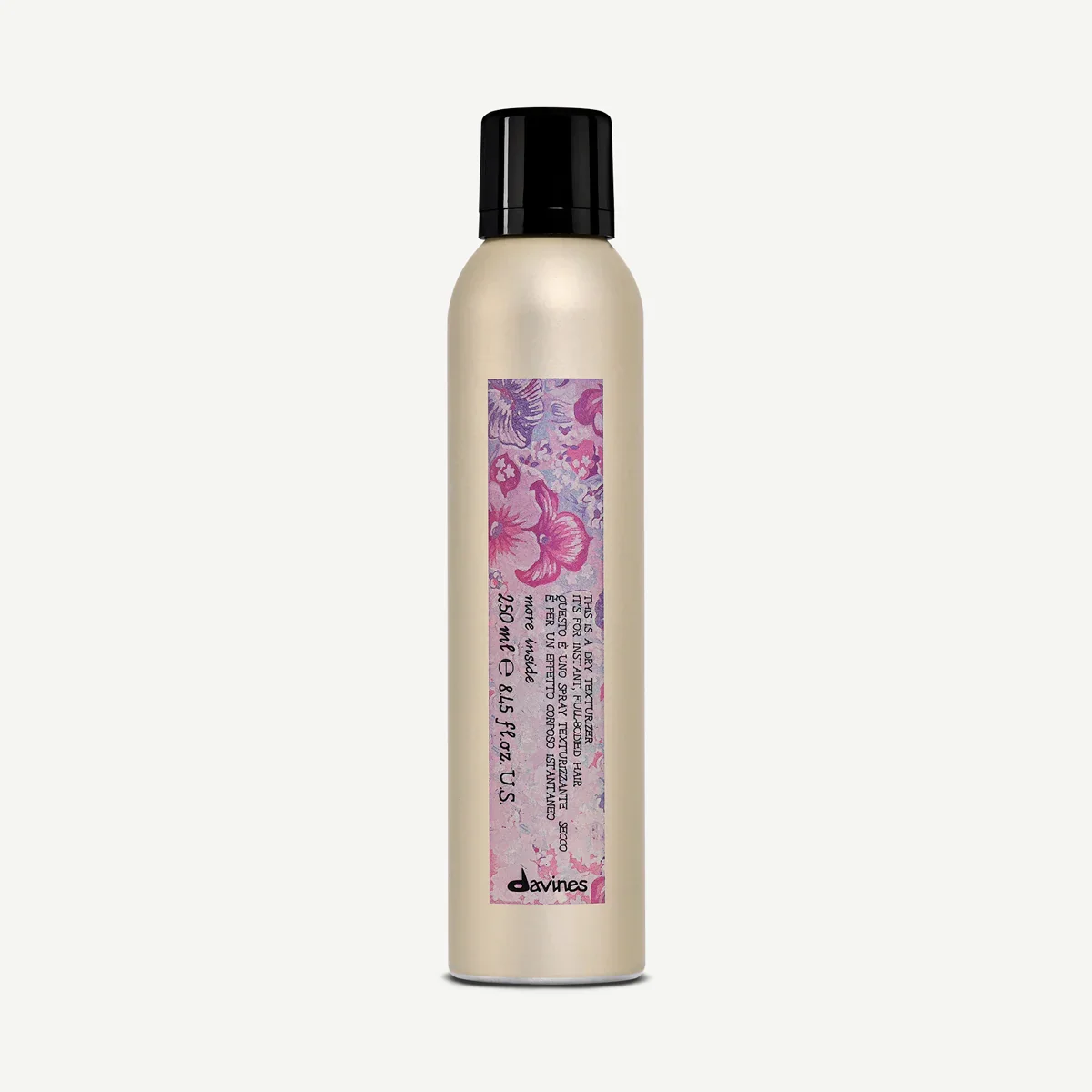 A cylindrical spray bottle with a black cap and a floral pink and purple label, containing Davines hair product.